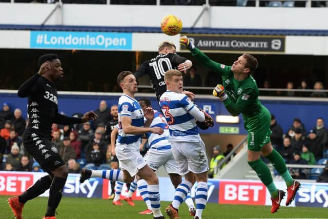 QPR goalkeeper Alex Smithies punches away an early Kemar Roofe cross.