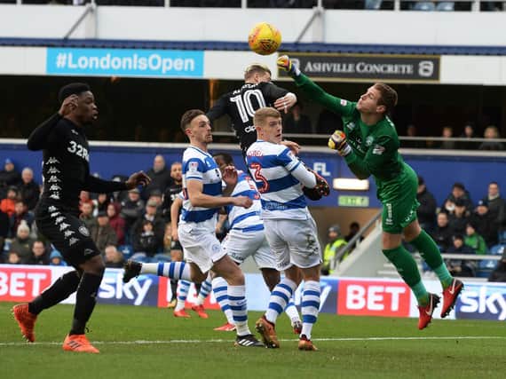 QPR goalkeeper Alex Smithies punches away an early Kemar Roofe cross.