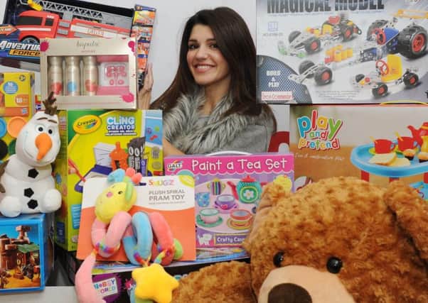 APPEAL: Natalie Anderson helping sort presents for Radio Aires Cash for Kids Mission Christmas Appeal.