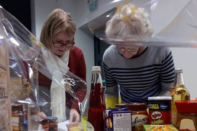 CARE AT CHRISTMAS: Volunteers pack the Christmas hampers for local families at Bridge Street Church.