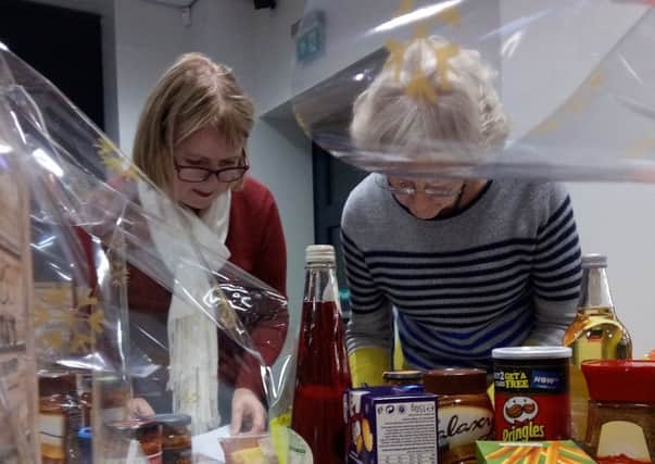 CARE AT CHRISTMAS: Volunteers pack the Christmas hampers for local families at Bridge Street Church.