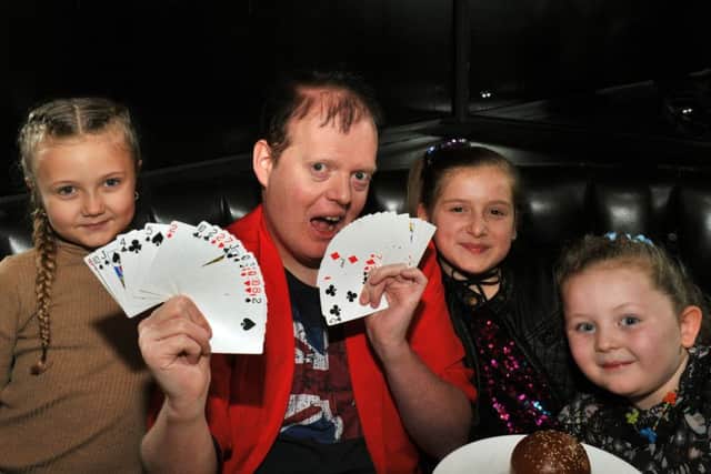 Magician Paul Dawson entertaining pupils from Windmill Primary School from Belle Isle in Leeds  at the Mission Christmas lunch at Gaucho's restaurant in Leeds