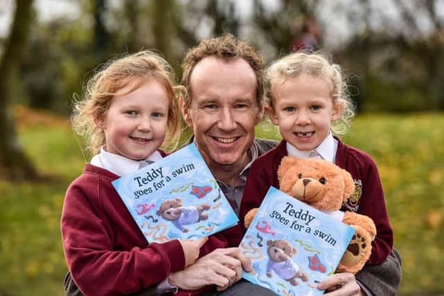 Adrian Johnson with his two daughters.