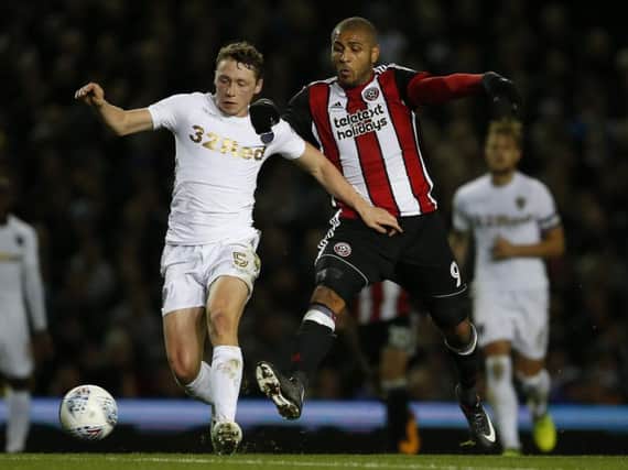 Matthew Pennington tussles with Leon Clarke during Leeds United's 2-1 defeat to Sheffield United in October.