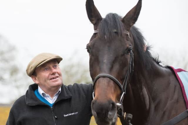 Trainer Nicky Henderson with Might Bite. PIC: Simon Galloway/PA Wire