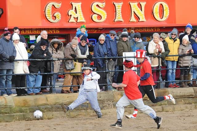 HEAD GAMES: Players in the charity football match wearing top hats on Scarborough South Beach. PIC: Paul Atkinson