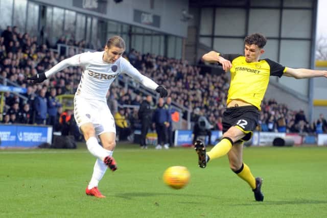 WIDE BOY: Leeds United's Pawel Cibicki crosses the ball as Burton's Tom Flanagan closes in.  Picture: Tony Johnson.