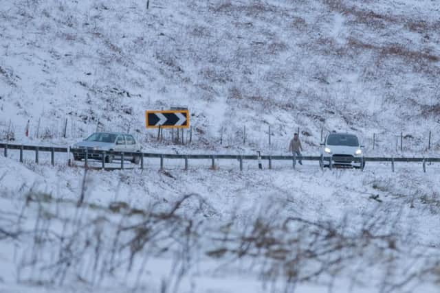 A car stuck on the road at Holme Moss. PIC: Charlotte Graham