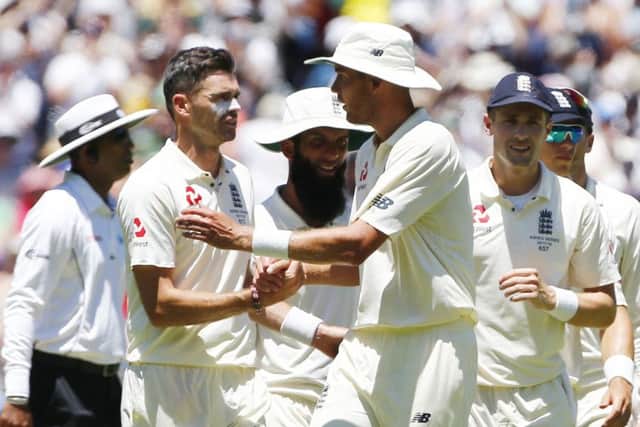 WELL DONE MATE: England's Stuart Broad and James Anderson shake hands duafter helping dismiss Australia for 327 on day two at the MCG. Picture: Jason O'Brien/PA