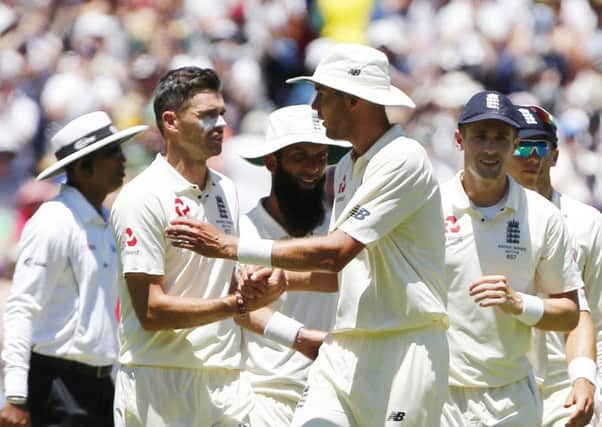 WELL DONE MATE: England's Stuart Broad and James Anderson shake hands duafter helping dismiss Australia for 327 on day two at the MCG. Picture: Jason O'Brien/PA