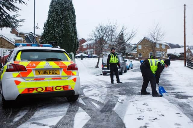 Police help residents clear snow from Vesper Lane in Leeds. PIC: SWNS