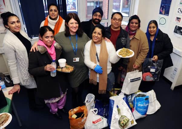 Volunteers from the Kalgidhar Gurudwara Sikh Temple in Leeds came to RAISE to provide food and warm clothing for their homeless clients.  Pictured with Resource centre manager Liz Knight.   
Picture Jonathan Gawthorpe