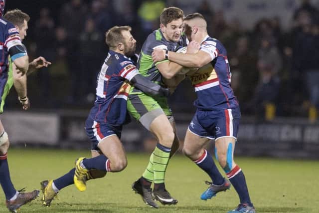 Yorkshire Carnegie's Jack Whetton is tackled by the Doncaster defence.