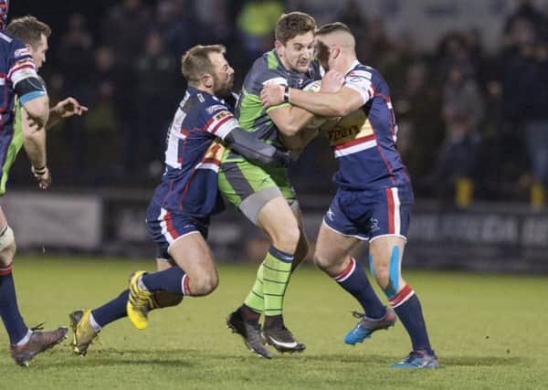 Yorkshire Carnegie's Jack Whetton is tackled by the Doncaster defence.