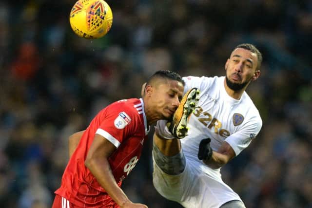 Kemar Roofe catches Michael Mancienne with his boot