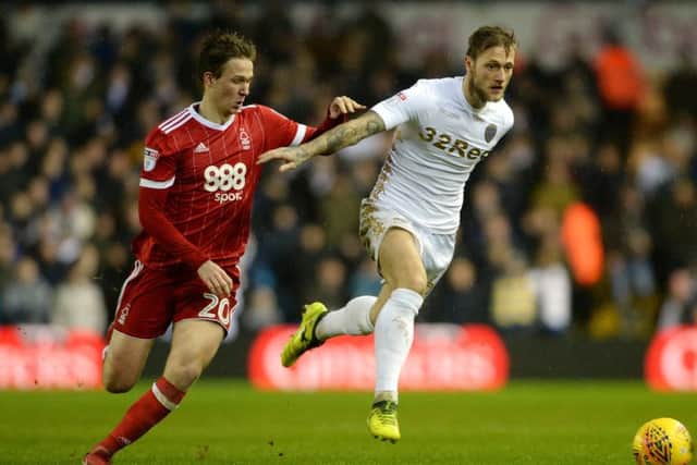 Whites skipper Liam Cooper gets clear of Forest's Kieran Dowell.