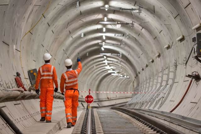 Crossrail engineers walk alongside completed tracks as the Crossrail project celebrates the completion of permanent Elizabeth line track in Whitechapel, east London. PRESS ASSOCIATION Photo. Issue date: Thursday September 14, 2017. The Elizabeth line will run from Reading and Heathrow in the west, through 42km of new tunnels under London to Shenfield and Abbey Wood in the east, adding 10 new stations and upgrading to 30 more to fully integrate new and existing infrastructure. See PA story TRANSPORT Crossrail. Photo credit should read: Dominic Lipinski/PA Wire