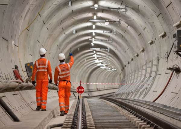 Crossrail engineers walk alongside completed tracks as the Crossrail project celebrates the completion of permanent Elizabeth line track in Whitechapel, east London. PRESS ASSOCIATION Photo. Issue date: Thursday September 14, 2017. The Elizabeth line will run from Reading and Heathrow in the west, through 42km of new tunnels under London to Shenfield and Abbey Wood in the east, adding 10 new stations and upgrading to 30 more to fully integrate new and existing infrastructure. See PA story TRANSPORT Crossrail. Photo credit should read: Dominic Lipinski/PA Wire