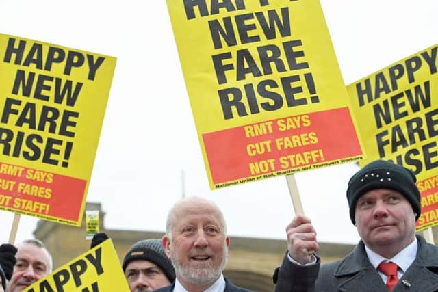 Shadow Transport Secretary Andy McDonald (centre) joins campaigners protesting against rail fare increases outside King's Cross station in London, before he set off for Leeds. PRESS ASSOCIATION Photo. Stefan Rousseau/PA Wire