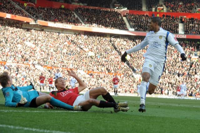 Jermaine Beckford slides the ball past Manchester United goalkeeper Tomasz Kuszczak and Wes Brown to score Leeds United's winning goal.