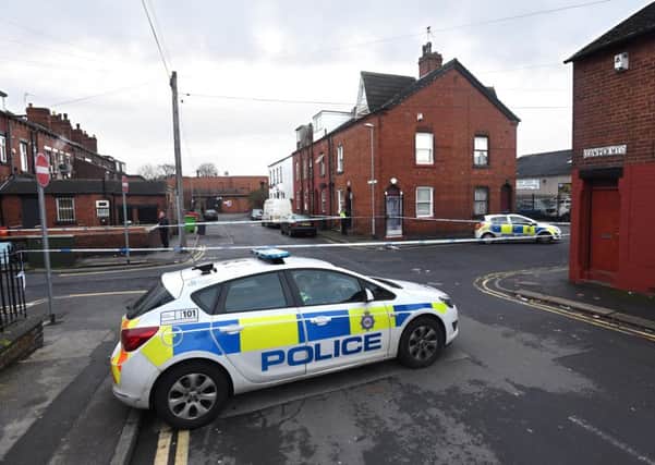 INVESTIGATION: A police car and cordon at Cowper Mount, Harehills, yesterday following the stabbing. PIC:  Guzelian