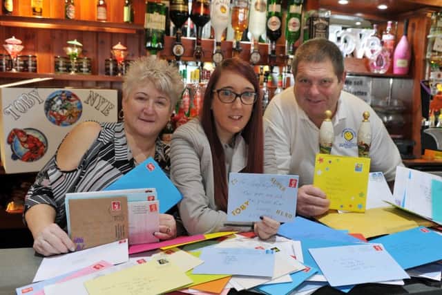 Publicans Lynn and Gary Barrass and bar worker Julie Ross, centre at the Hope Inn on York Road, Leeds with birthday cards for Toby Nye who celebrates his fifth birthday today. (Sat Jan 6) Picture Tony Johnson