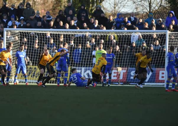 OUT AGAIN: Newport's players turn to celebrate after Shawn McCoulsky scores the winning goal. Picture by James Hardisty.