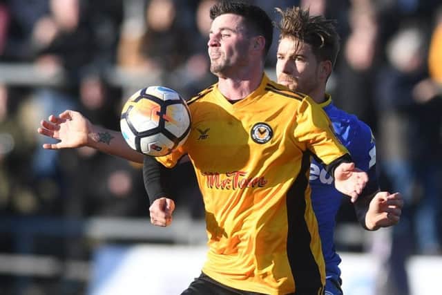 Padraig Amond, of Newport County, is muscled out by Leeds United man of the match Gaetano Berardi. PIC: James Hardisty