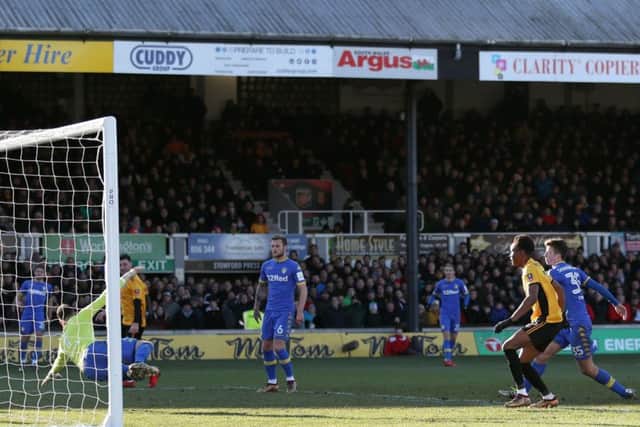 BAD LUCK: Leeds United's Conor Shaughnessy (right) scores an own goal at Rodney Parade. Picture: David Davies/PA