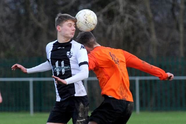 Wyke Wanderers' Ryan Clay goes head to head with Joe Straker of Wetherby Athletic. PIC: Steve Riding