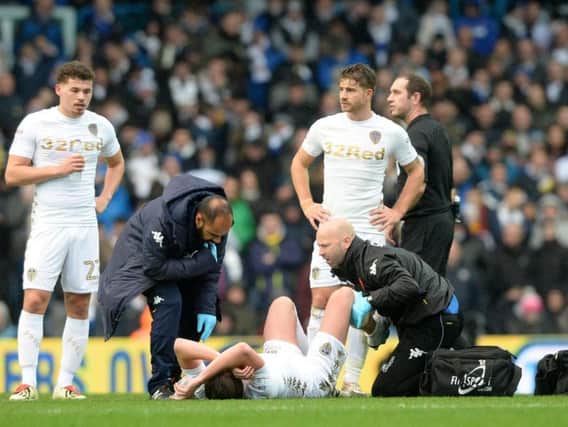 Luke Ayling receives treatment on the field during Leeds' 0-0 draw with Nottingham Forest.