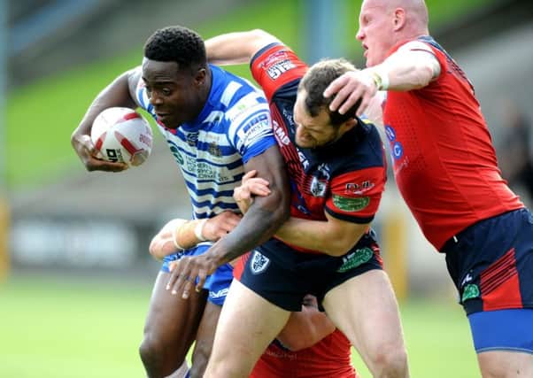 Halifax's Rob Worrincy is tackled by the Featherstone defence.