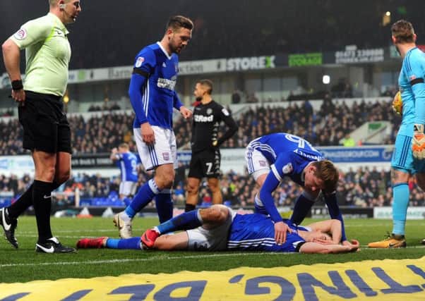 THEATRICAL: Ipswich Town's Jonas Knudsen clutches his face following the clash with Leeds United's Eunan O'Kane who was sent off. Picture by Simon Hulme.