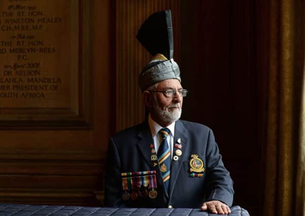 Mohammed Saddique, 88, wears medals won by his father Ghulam Hassan during naval service in both world wars. Picture: Bruce Rollinson