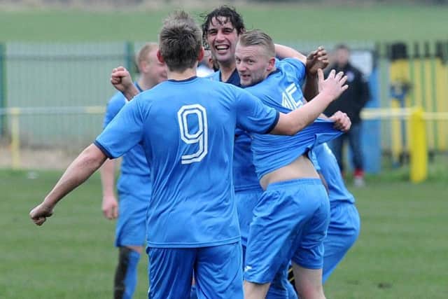 Whitkirk Wanderers goalscorer 
Jamie Hainsworth, centre, is mobbed by team-mates after scoring against Brighouse. PIC: Steve Riding