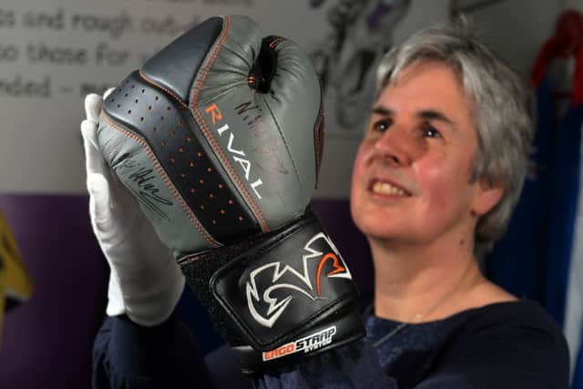 'A Womans Place' a new exhibition at Abbey House Museum, Leeds.
Pictured is Curator Kitty Ross with one of Nicola Adams boxing gloves.
18 january 2018.  Picture Bruce Rollinson