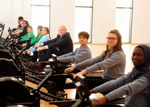 VISION: Sir John Townsley with pupils from Hillcrest Primary School and Ruth Gorse Academy, on the rowing machines at the academy.