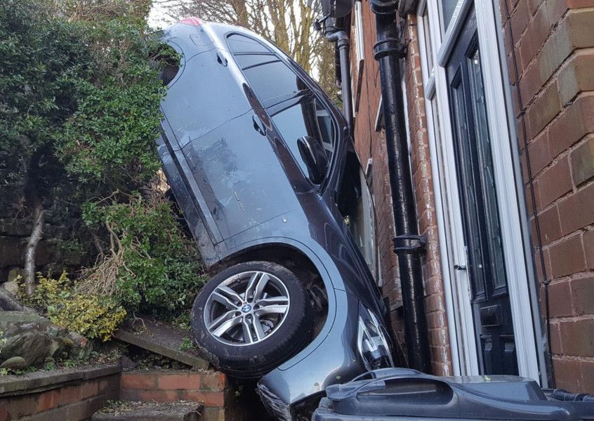 PICTURES: Car wedged outside house after hurtling over garden wall in ...