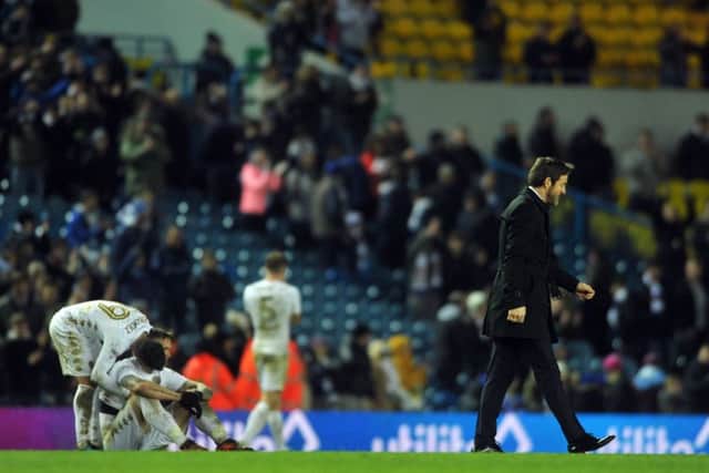 NOT QUITE: Leeds United head coach Thomas Christiansen, far right, trudges off the pitch as Pablo Hernandez consoles Pontus Jannson at end the of the game.  Picture: Tony Johnson.