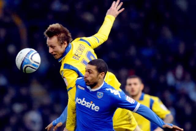 Luciano Becchio, jumps to heads the ball over Portsmouth's Hayden Mullins.