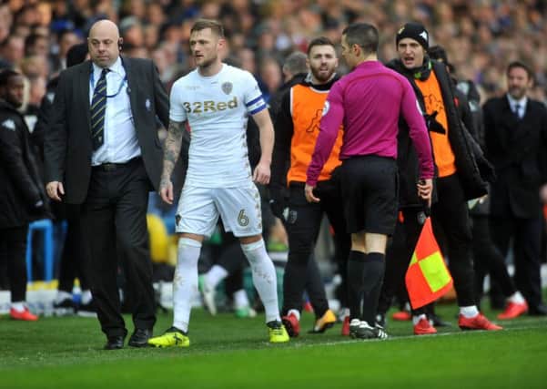 THIRD IN A ROW: Leeds United captain Liam Cooper is given his marching orders following his late tackle on Millwall's George Saville, United's third red card from their last three games. Picture by Tony Johnson.
