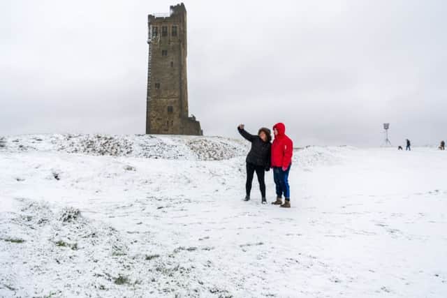 Date: 21st January 2018.
Picture James Hardisty.
Heavy snow fall over part of Yorkshire, pictured Lindsey Joyce, and Sadie Lancaster, of Hudderfield, take a selfie infront of Castle Hill, Huddersfield, West Yorkshire.