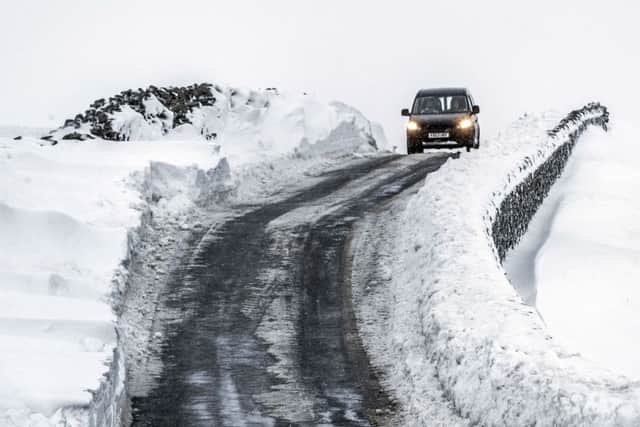 A vehicle navigates in snowy conditions near Fleet Moss in the Yorkshire Dales National Park. PRESS ASSOCIATION Photo. Picture date: Sunday January 21, 2018. People across the country are braced for more snow after the UK froze on the coldest night in nearly two years. See PA story WEATHER Snow. Photo credit should read: Danny Lawson/PA Wire