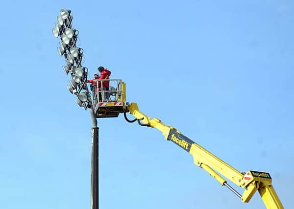 GAME READY: Workmen carry out floodlight maintenance at Wakefield Trinitys Belle Vue Stadium. PIC: Scott Merrylees