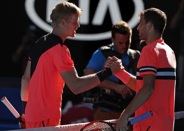 Winner: Kyle Edmund, left, shakes hands with Grigor Dimitrov after winning their quarter-final at the Australian Open.