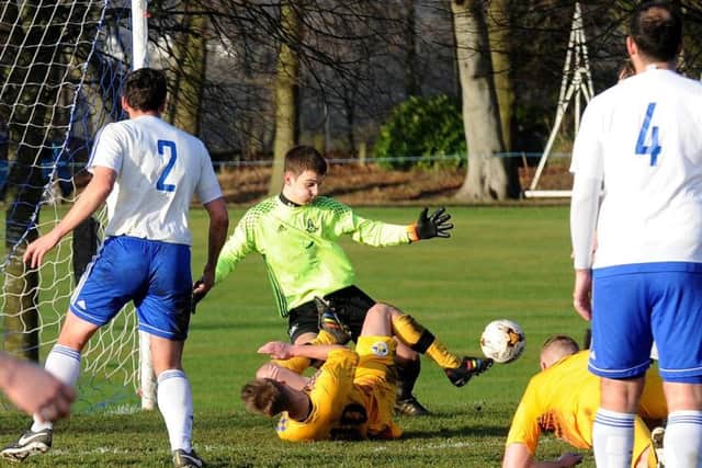 Leeds City OB goalkeeper, Liam Davies, saves under pressure during his side's 3-2 West Riding County Trophy victory over visitors Garforth Crusaders. PIC: Steve Riding