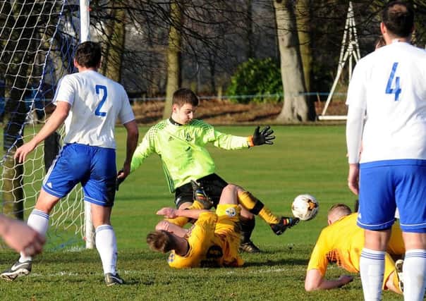 Leeds City OB goalkeeper, Liam Davies, saves under pressure during his side's 3-2 West Riding County Trophy victory over visitors Garforth Crusaders. PIC: Steve Riding