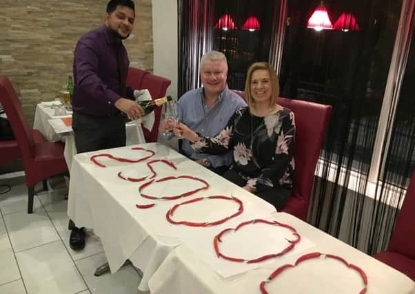 CHEERS: Tingley Balti House owner Rob Rahman celebrates with Duncan and Allison Innes.