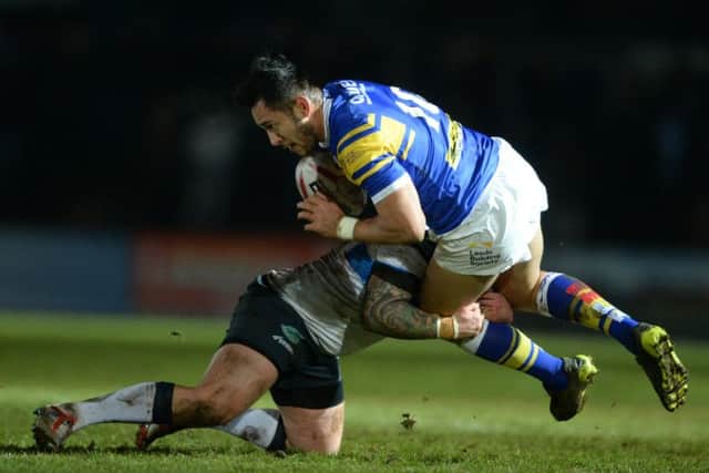 Leeds' Nathaniel Peteru is held by Rovers' John Davies.