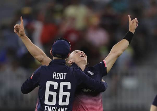 MAGIC MAN: England's Tom Curran, right, celebrates with Joe Root after taking Australia's final wicket in Perth. Picture: AP/Trevor Collens